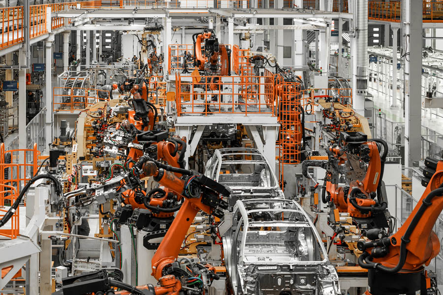 Photo of automobile production line. Welding car body. Modern car assembly plant. Auto industry. Interior of a high-tech factory, modern production